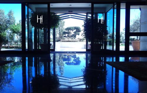 a building with a reflection of a pool of water at Hotel Liola' in Castrocielo