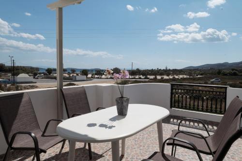 a white table and chairs on a balcony at Asteras in Antiparos Town