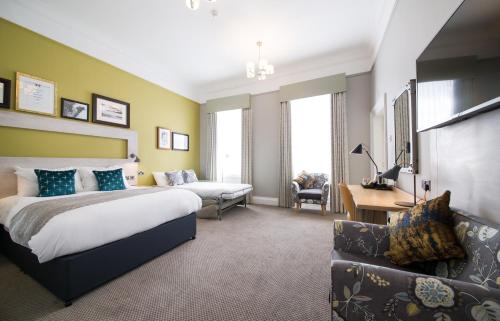 a hotel room with a bed and a couch at The Hedgehog by Innkeeper's Collection in Lichfield
