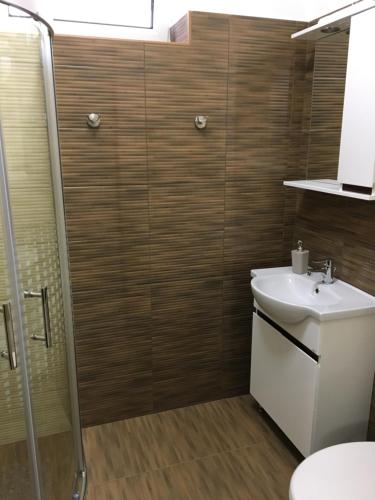 a bathroom with a toilet and a sink and a shower at Kristály apartmanok in Kisvárda