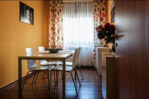 a dining room with a table and chairs and a window at Bellarmino Boutique Apartments, Montepulciano in Montepulciano