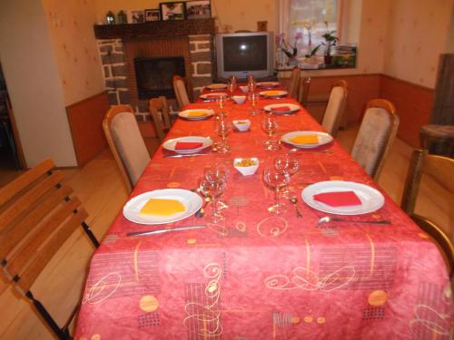 a long table with plates and wine glasses on it at Caux-Breizh in Rohan