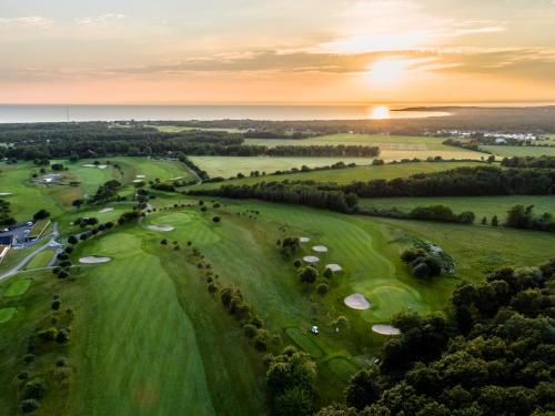 an aerial view of a golf course at sunset at Ringenäs Hotell & Konferens in Halmstad
