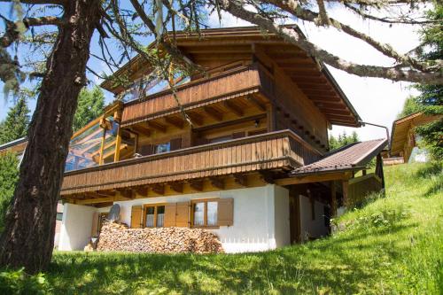 a house built on top of a pile of wood at Gomig Hütte in Obernussdorf
