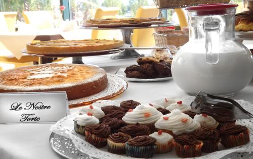 a table with cakes and other desserts on display at Hotel Liola' in Castrocielo