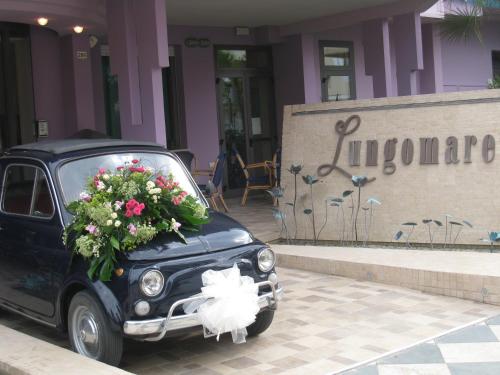 a car with a flower arrangement on the front at Hotel Lungomare in Cesenatico