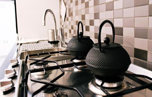 a stove top with three pots on top of it at La Palummara in San Panfilo dʼOcre
