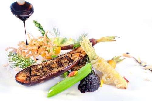 a plate of food with vegetables on a white background at Sun City Hotel - The Gabriel in Cairo