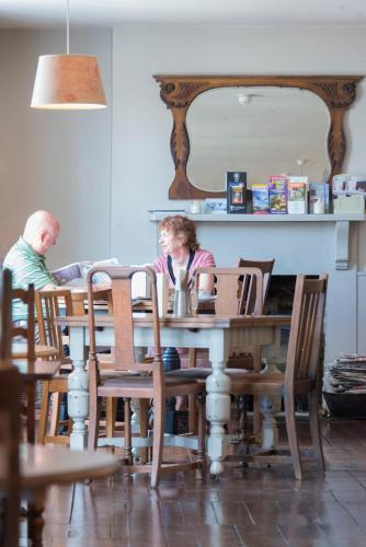 a man and a woman sitting at a table at The Swan in Wedmore