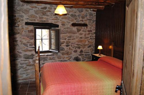 CampellesにあるApartaments turistics Moli Can Collの石壁のベッドルーム1室(ベッド1台付)