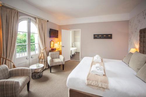 a bedroom with a bed and a living room at The Swan in Wedmore