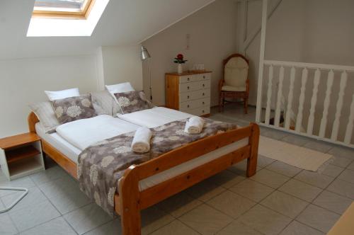 a bedroom with a bed with a teddy bear on it at Apartman Rosé in Eger