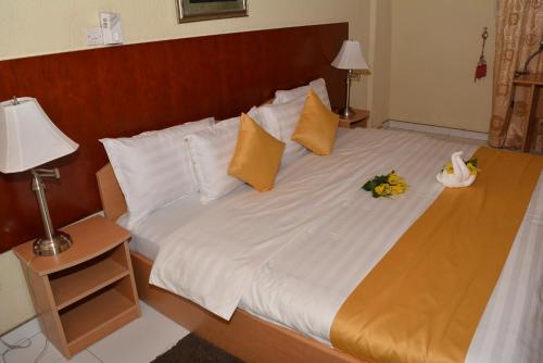 a bedroom with a large bed with flowers on it at Eusbett Hotel in Sunyani