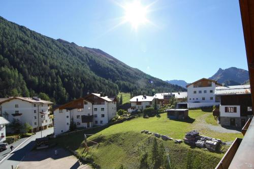a view of a small village with a mountain at Hotel Cresta in Samnaun