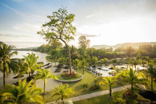 an aerial view of a resort with a river and palm trees at ROBINSON KHAO LAK in Khao Lak
