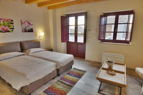 a bedroom with a bed and a couch and a table at La Mirolla in Capannori