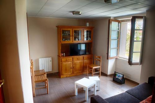 a living room with a tv and a cabinet at Casa Saleta in Melide