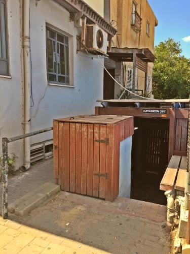 a building with a wooden gate in front of a building at Dotan's Boutique Guesthouse - By The Beach! in Tel Aviv