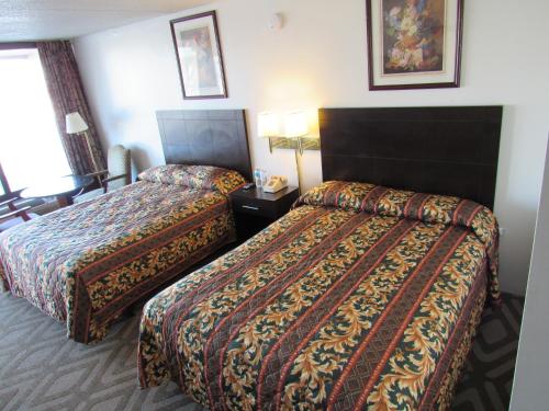 a hotel room with two beds and two lamps at Tourway Inn in Birmingham