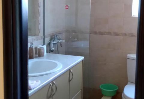 a bathroom with a sink and a toilet at Villa Xristos Kalogeris in Ksamil
