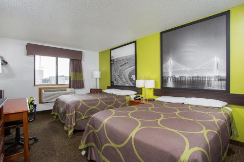 a hotel room with two beds and a desk at Super 8 by Wyndham Franklin in Franklin