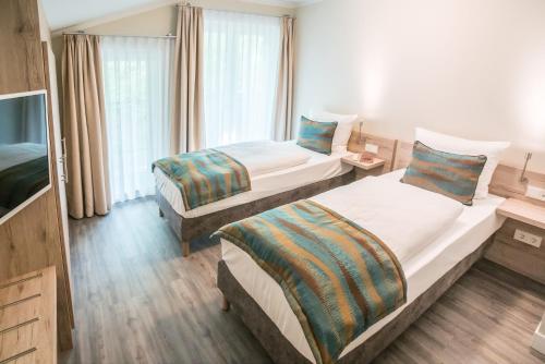Postel nebo postele na pokoji v ubytování AKZENT Apartmenthotel Residenz