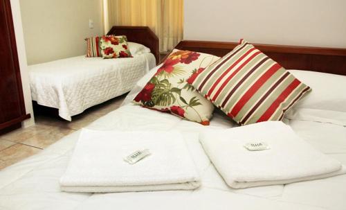 a hotel room with two towels on a bed at Hotel Daieli in Otacílio Costa