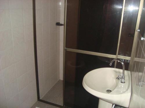 a bathroom with a shower and a sink at Dona Quinota in Ilha do Mel