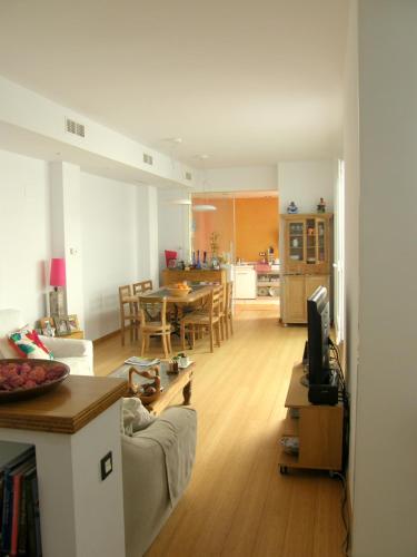 a living room with a couch and a dining room at B&B Casa Alfareria 59 in Seville