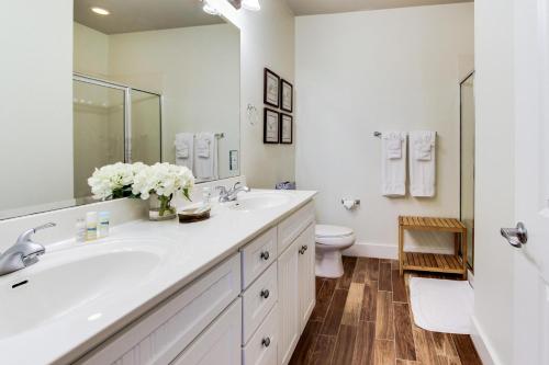 een witte badkamer met een wastafel en een toilet bij Point West Resort in Galveston