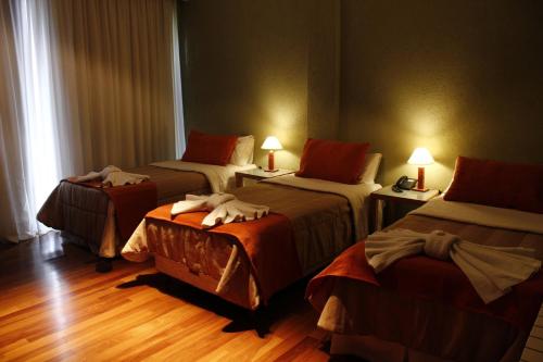 A bed or beds in a room at Tres Pircas Hotel & Spa