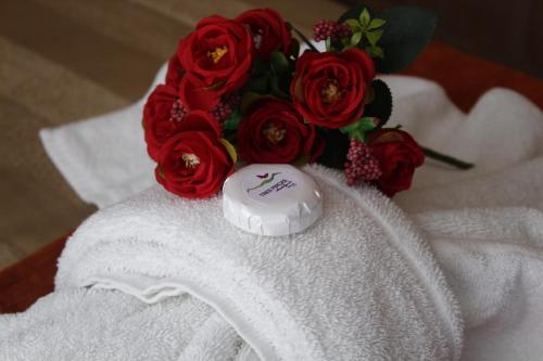 un ramo de rosas rojas sentadas encima de una toalla en Tres Pircas Hotel & Spa en Huerta Grande
