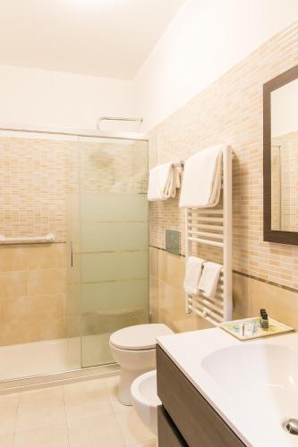a bathroom with a toilet and a shower and a sink at Hotel Alpi Resort in Turin