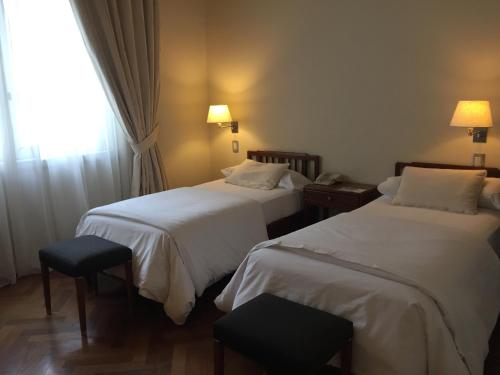 a hotel room with two beds and a window at NH Gran Hotel Provincial in Mar del Plata