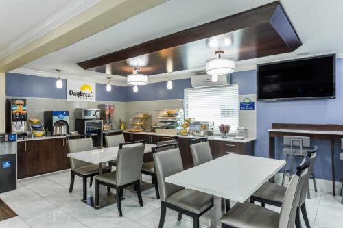 a dining room with tables and chairs in a restaurant at Days Inn by Wyndham Goose Creek in Charleston