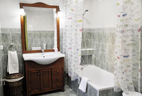 a bathroom with a sink and a shower curtain at Laurel 12 in Logroño