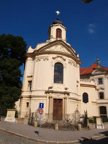 a large white church with a cross on top of it at Hotel U Zvonu in Kutná Hora