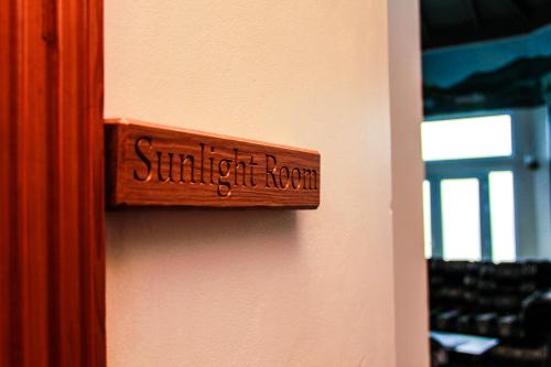 a wooden sign that reads student room on a wall at Sunshine Lodge: Your home away from home in Montego Bay