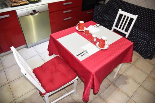 a red and white table with two chairs and a kitchen at Villa Turati in Pescara
