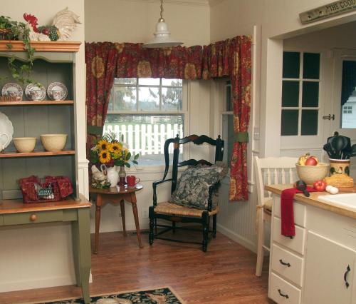 a kitchen with a chair and a window at Cottage on Armstrong in Lodi