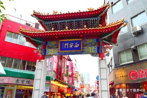 a street with a chinese sign in a city at Hostel Anchorage in Kobe