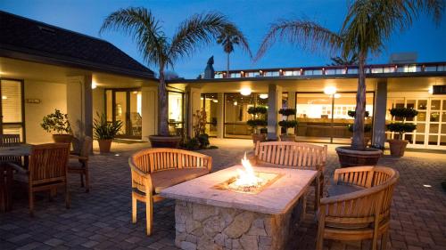 a patio with a table and chairs and a fire pit at Carmel Mission Inn in Carmel
