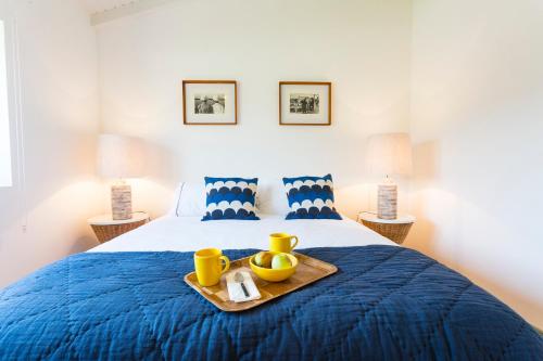 a bedroom with a bed with a tray of food on it at Quinta do Gato, Douro Valley, Armamar in Armamar