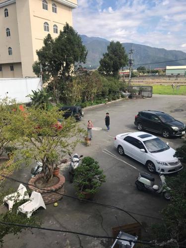 a car parked in a parking lot next to a building at Puli Islet Inn in Puli