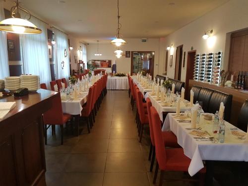 a row of tables and chairs in a restaurant at Penzión Ľadoveň SKVELÁ KUCHYŇA A RODINNÁ ATMOSFÉRA in Martin