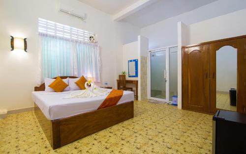 a bedroom with a large bed in a room at Blossoming Romduol Boutique in Siem Reap