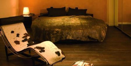 a bedroom with a bed and a chair and a table at Joia Hotel & Luxury Apartments RTA in Brusaporto