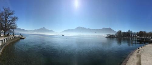 a large body of water with mountains in the background at Wohnung Schloss Mondsee in Mondsee