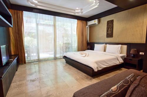 Postel nebo postele na pokoji v ubytování V Condominium Samui