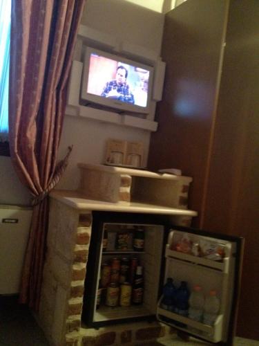 a small refrigerator with a television in a room at Ca'Nova Alloggi in Campalto